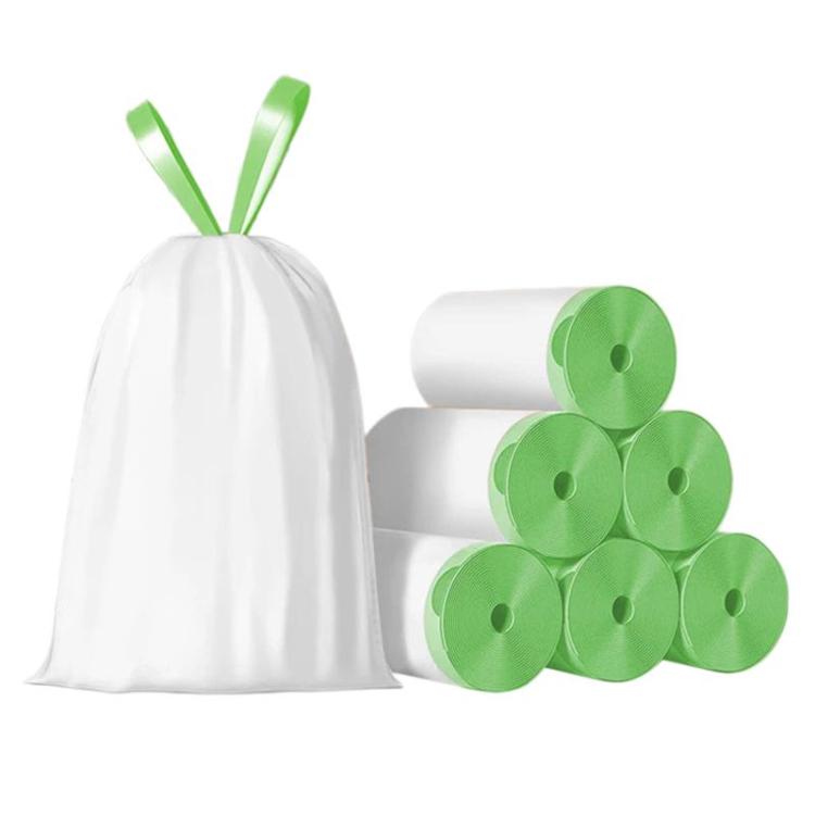 White drawstring trash bags and rolls of green trash bags with leaf accents
