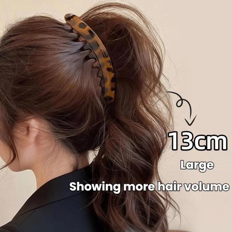 Large tortoise banana hair clip with curved prongs, holding a high ponytail