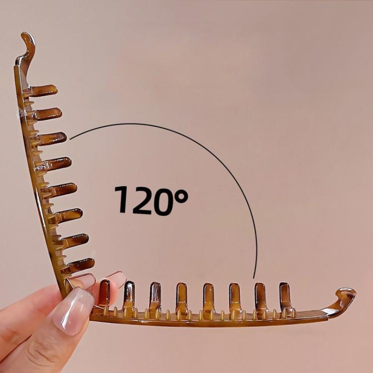 Brown banana hair clip with metal prongs, curved for securing hair volume