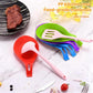 Green kitchen mat with pink, blue, and purple silicone spatula rests