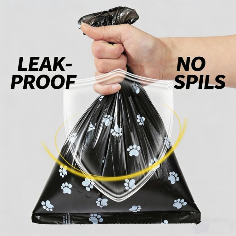 Black dog waste bag with blue paw-print pattern held for secure tying