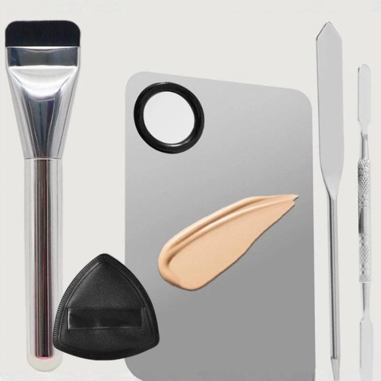 Makeup foundation brush with spatula mixing tools, ring palette, and powder puff