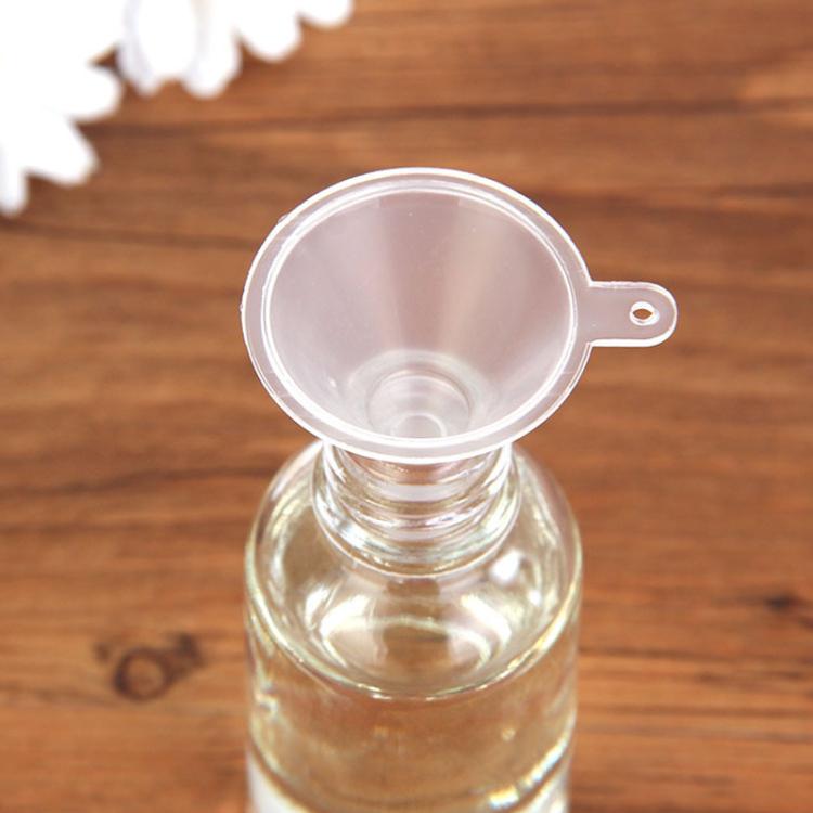 Clear mini funnel with round opening and handle tab, designed for bottle filling