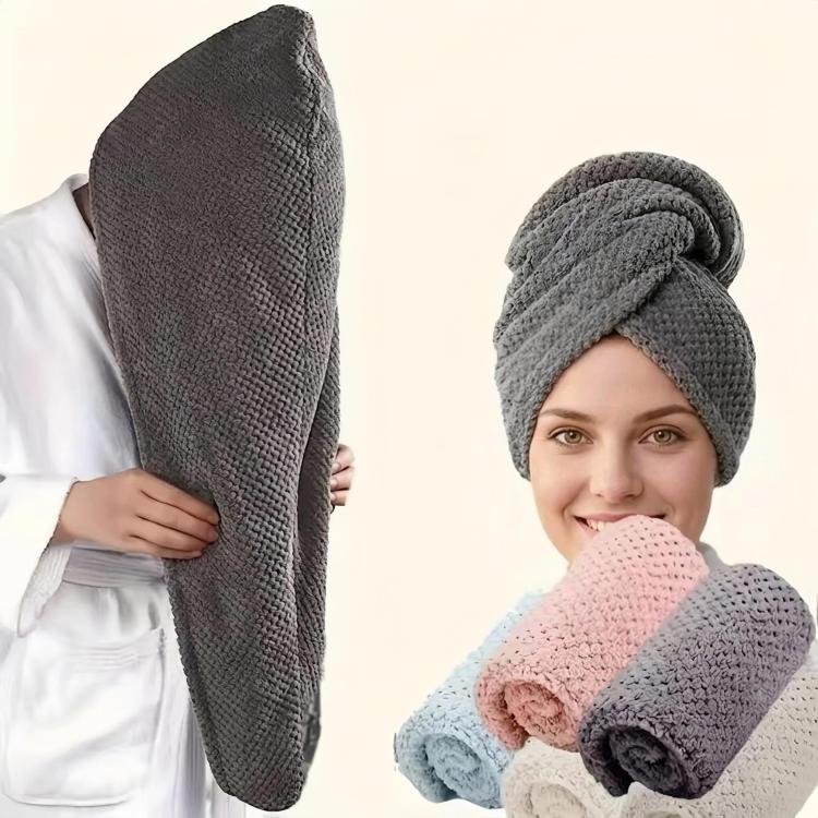 Dark gray hair drying cap worn on head with folded pastel towels
