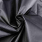 Black BBQ grill cover fabric close-up with smooth draped texture
