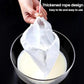 White filter bag with tied rope top over a bowl of pale liquid.