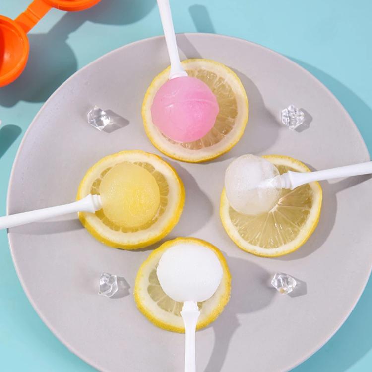 Lollipop ice pops on a plate with lemon slices and white sticks