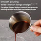 Stainless steel 100ml coffee cup with spout and measurement lines, held while pouring