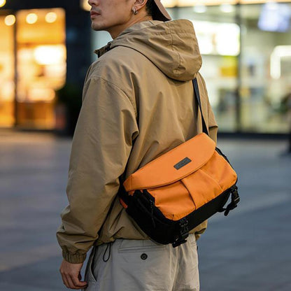 Orange DSLR shoulder bag with flap over front and adjustable crossbody strap