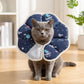 Cat wearing a soft anti-lick recovery cone collar, navy space pattern with light lining