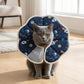 Soft recovery cone collar on a cat, navy blue space pattern with white trim