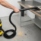 Black vacuum extension tubes with hose assembly and floor nozzle attachment