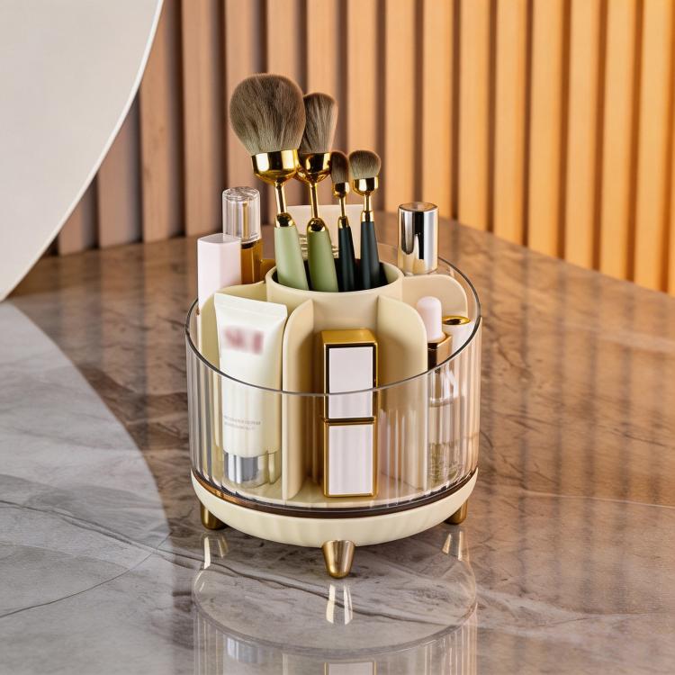 Champagne 360-degree rotating makeup organizer with clear body and gold brush holders