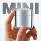 Mini electric shaver in small metal housing held in hand