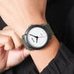 SKMEI unisex watch with dark case, white dial, and olive-green fabric strap