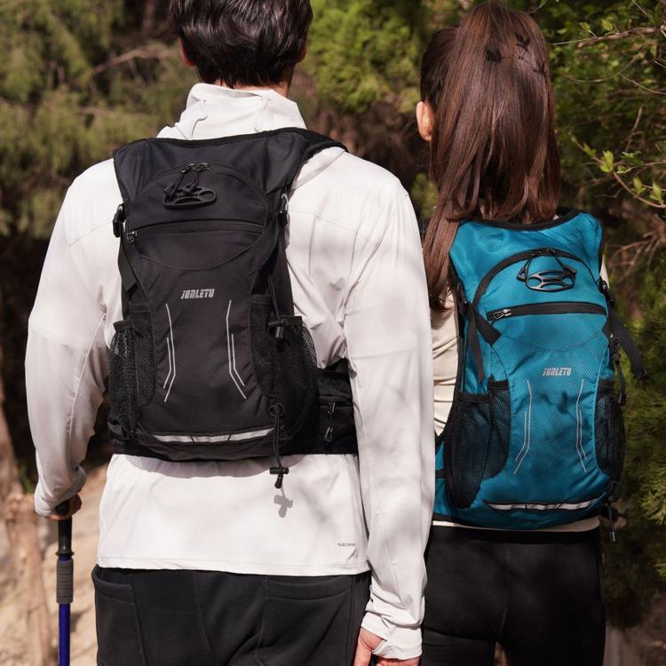 Waterproof cycling backpack in black worn with adjustable shoulder straps and handle loop