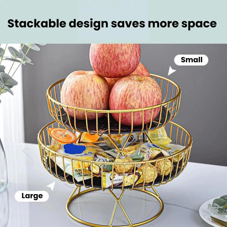 Stackable two-tier wrought iron fruit stand with gold frame holding apples and wrapped candies.