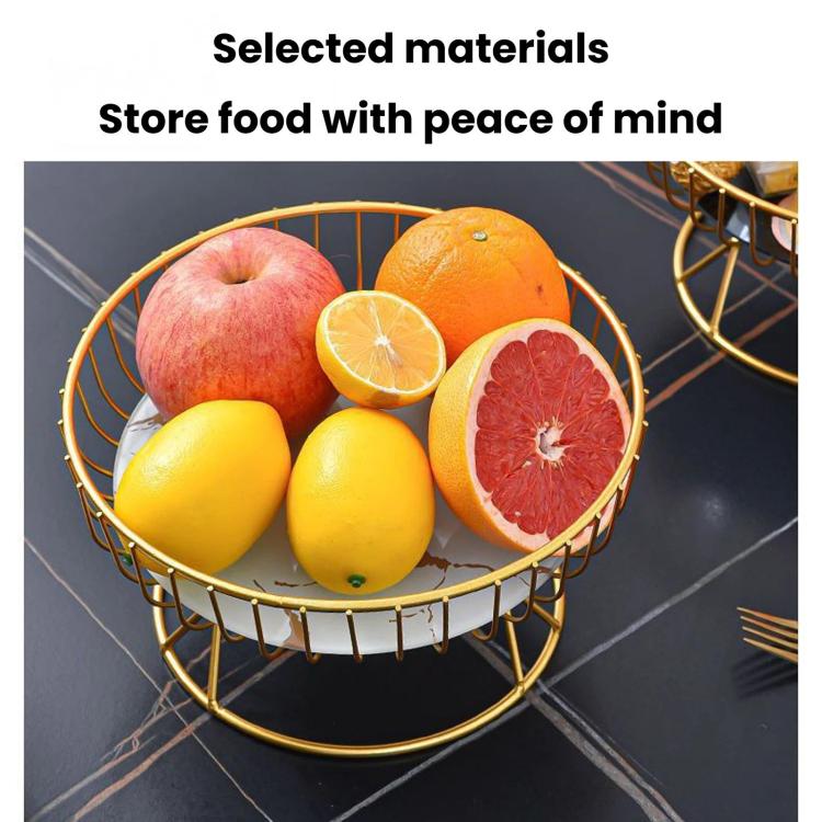 Round wrought iron fruit tray with gold stand holding apples, oranges, lemon, and grapefruit.