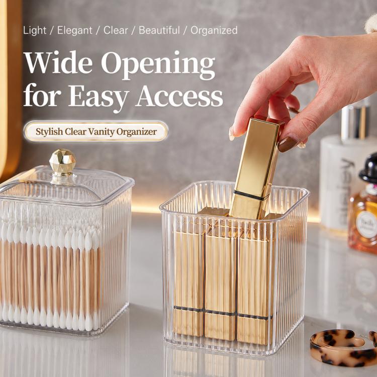 Clear cotton swab organizer with gold-knob lid being opened by hand