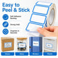 Self-adhesive labels roll; hand peels backing to stick blank blue-bordered labels