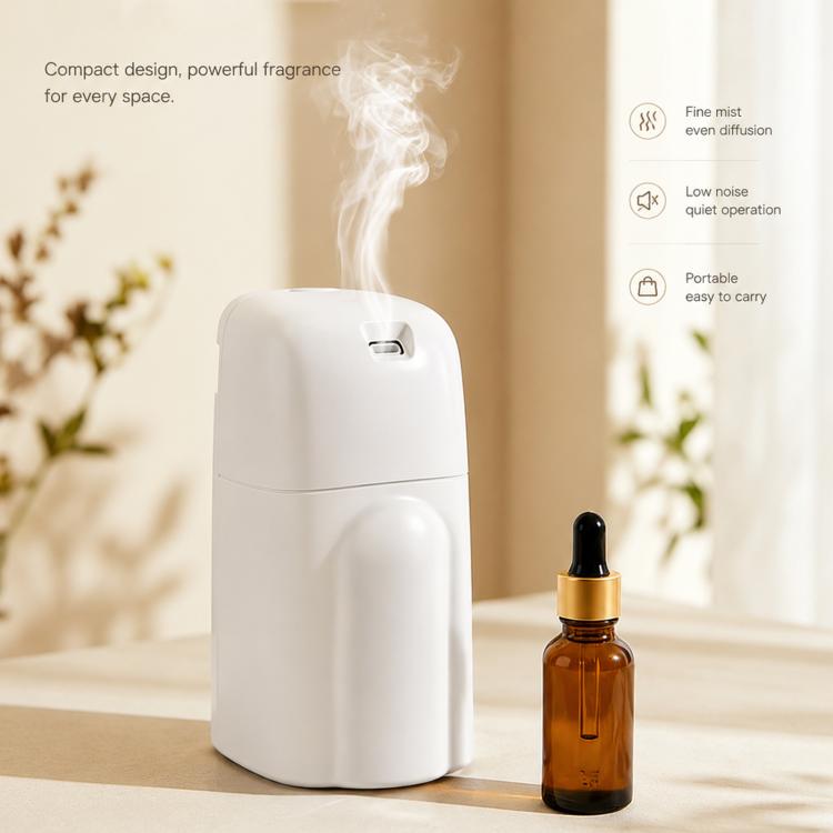White compact aroma diffuser with essential oil bottle and mist