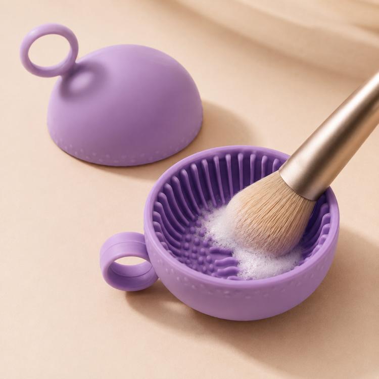 Purple silicone makeup brush cleaning bowl with handle loop and scrubbing ridges