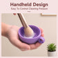 Purple handheld silicone brush cleaning bowl with makeup brush scrubbing the surface
