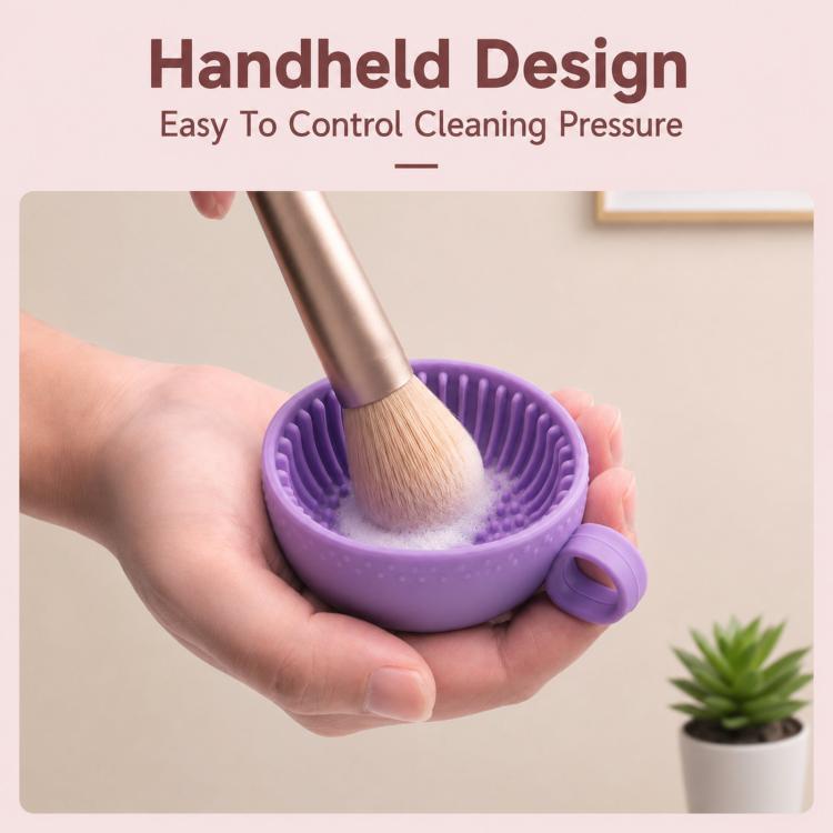 Purple handheld silicone brush cleaning bowl with makeup brush scrubbing the surface