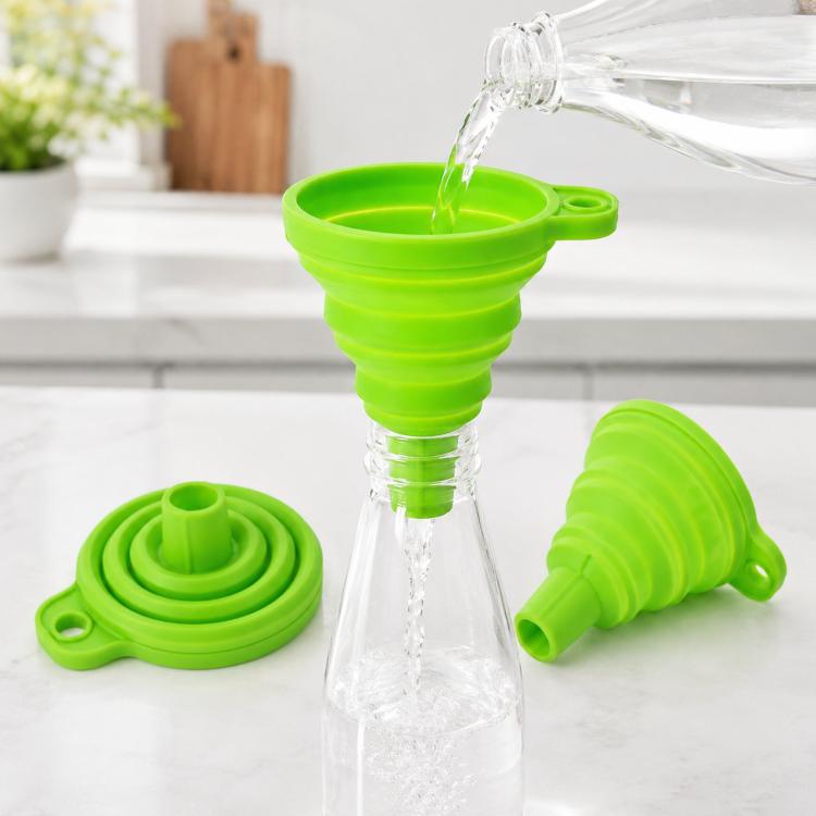 Green collapsible silicone funnel with pouring spout and folded base pieces