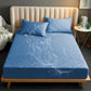 Dark blue waterproof fitted crib sheet with quilted texture and raised edge, 153x203 cm.