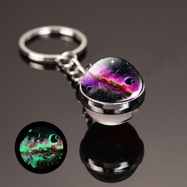 Galaxy crystal ball keychain with silver keyring and chain, purple and green glow.