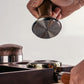 Constant force coffee tamper showing threaded stainless steel bottom and wood handle