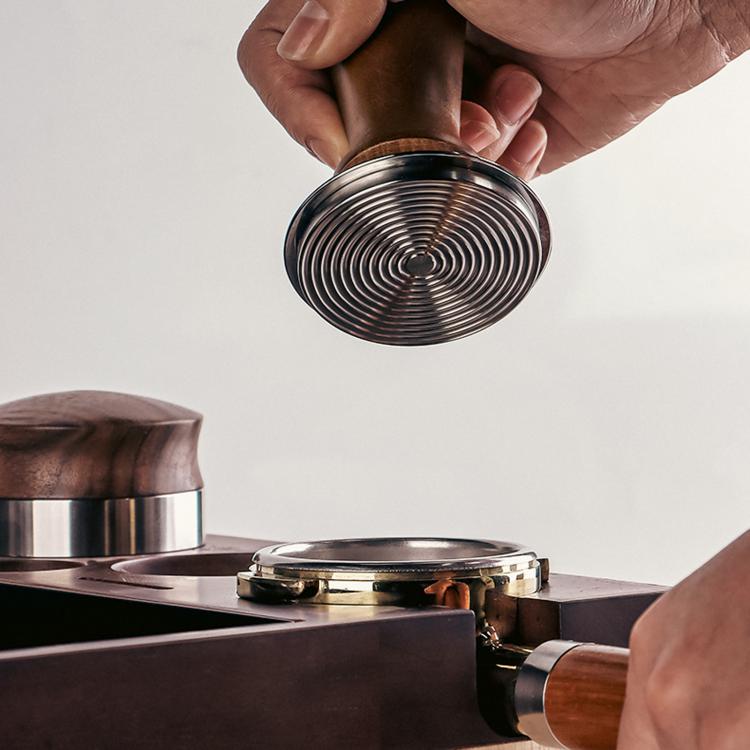 Constant force coffee tamper showing threaded stainless steel bottom and wood handle