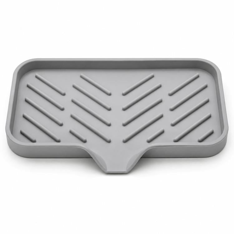 Gray slanted silicone sink tray with ridged grooves and central outlet for draining