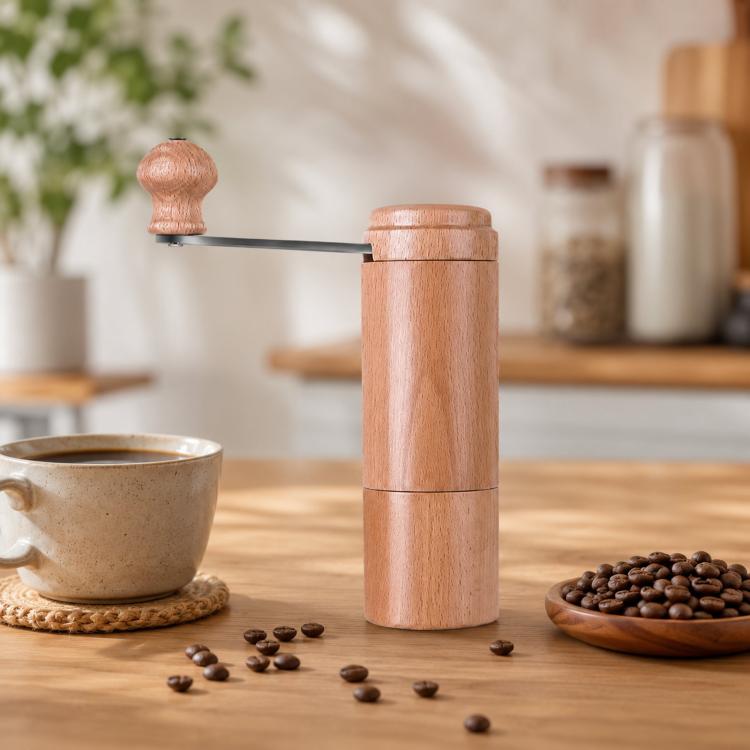 Light wood hand-cranked coffee grinder with metal crank and two-piece body