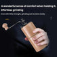 Hand-cranked wooden coffee grinder with light beechwood body, held in hand