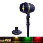 Round in-ground laser light fixture with dark blue cylindrical head and spike stake