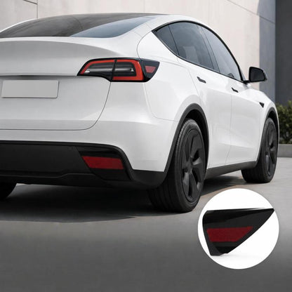 Black rear taillight trim panel with red reflector, mounted on a white car.