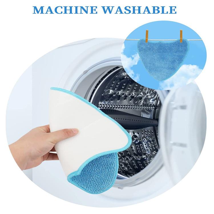 Blue microfiber steam mop pad held near a washing machine drum