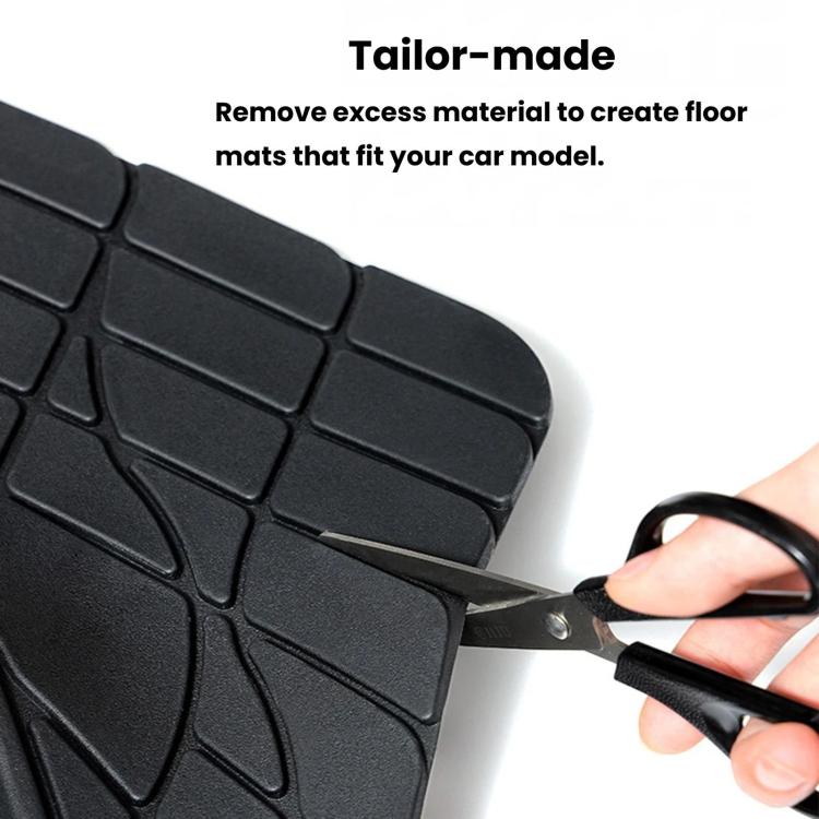 Trim-to-fit silicone car floor mat being cut to shape with scissors