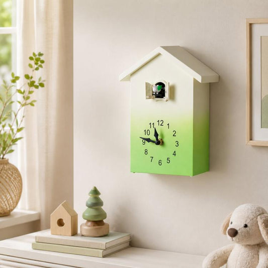 House-shaped wall clock with green gradient face, black hands, and bird chime window