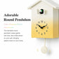 House-shaped wall clock with yellow gradient face, black hands, and round pendulum
