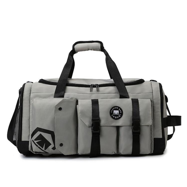 Grey gym travel bag with black straps, front flap pocket, and logo patch.