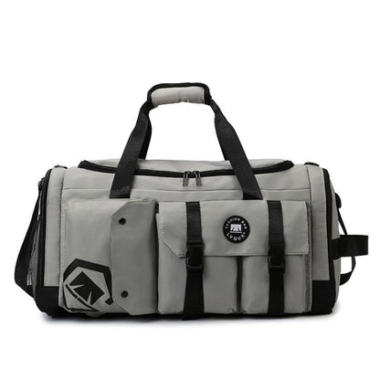 Grey gym travel bag with black straps, front flap pocket, and logo patch.