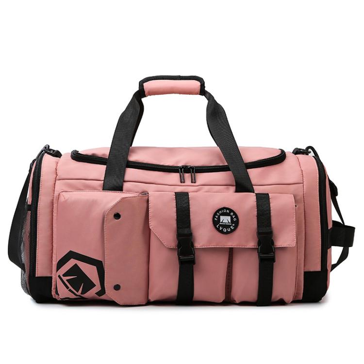 Pink gym travel bag with black straps, front flap pocket, and logo patch.