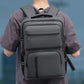 Men's gray backpack worn front view with front pockets and adjustable shoulder straps