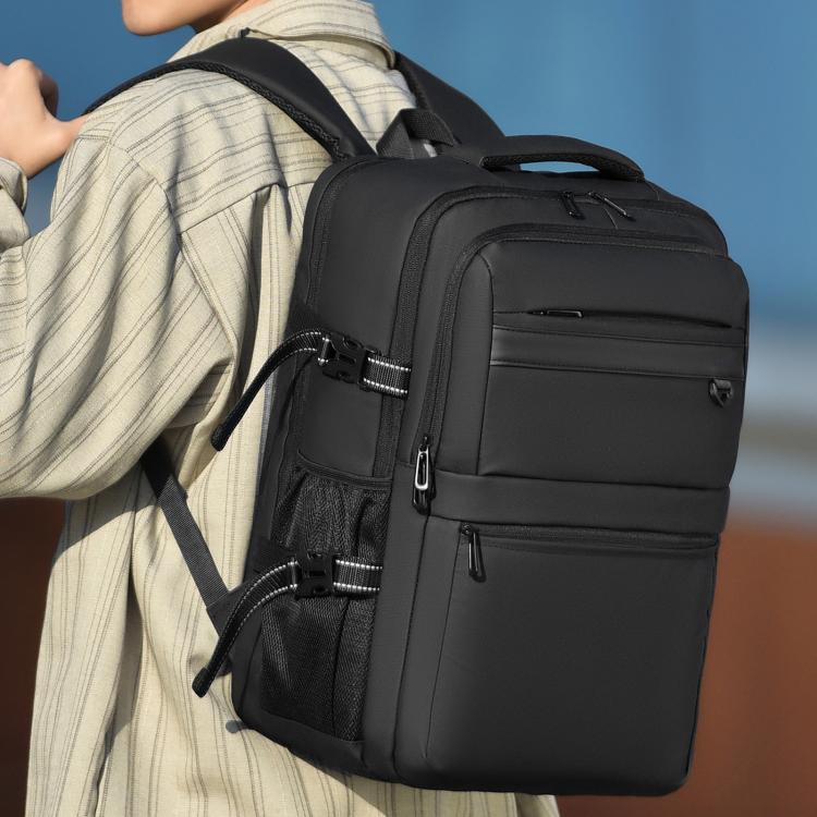 Black business backpack with front zip pockets, top handle, and adjustable shoulder straps