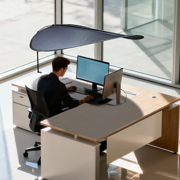 Indoor sunshade curtain in dark color over desk, attached to window with telescopic support