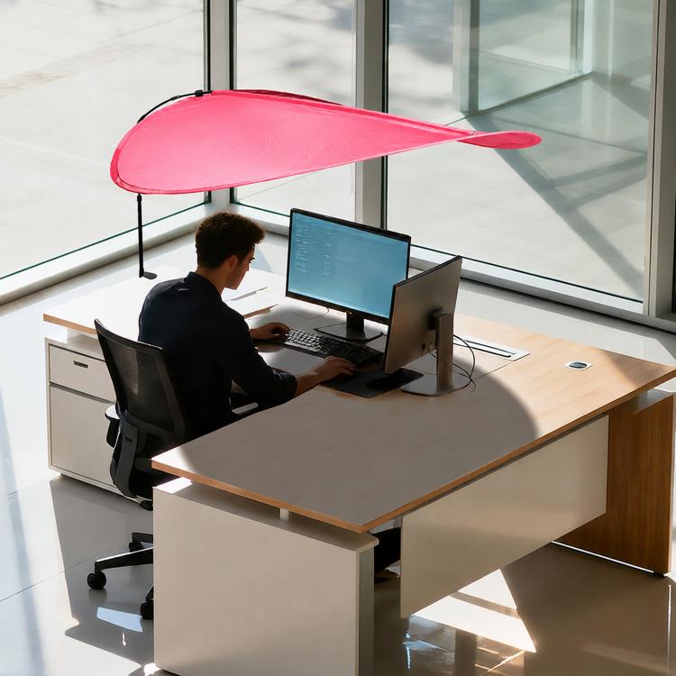 Indoor sunshade curtain in red over office desk, curved canopy attached to telescopic pole