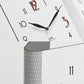 Corner wall clock with white face, black hands, and large colored numbers